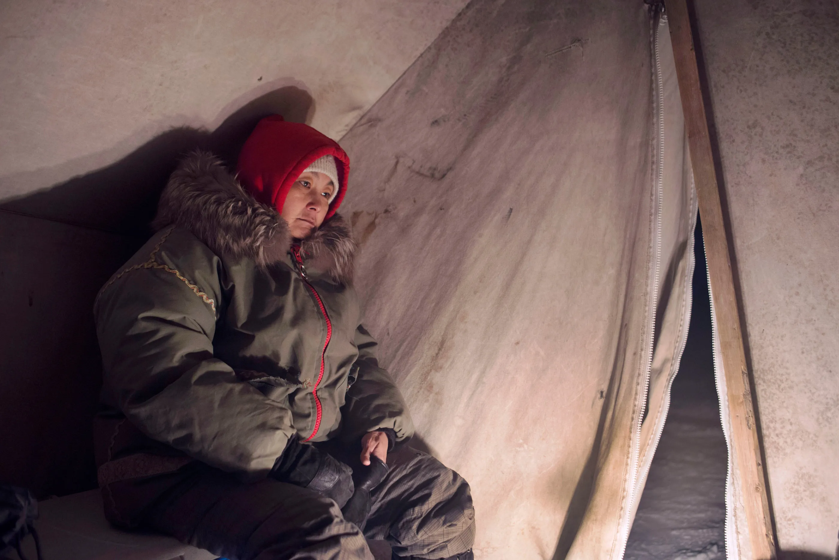 Master Corporal Susie Hiqinit rests inside a tent on a multi-day Canadian Ranger patrol in the wilderness.