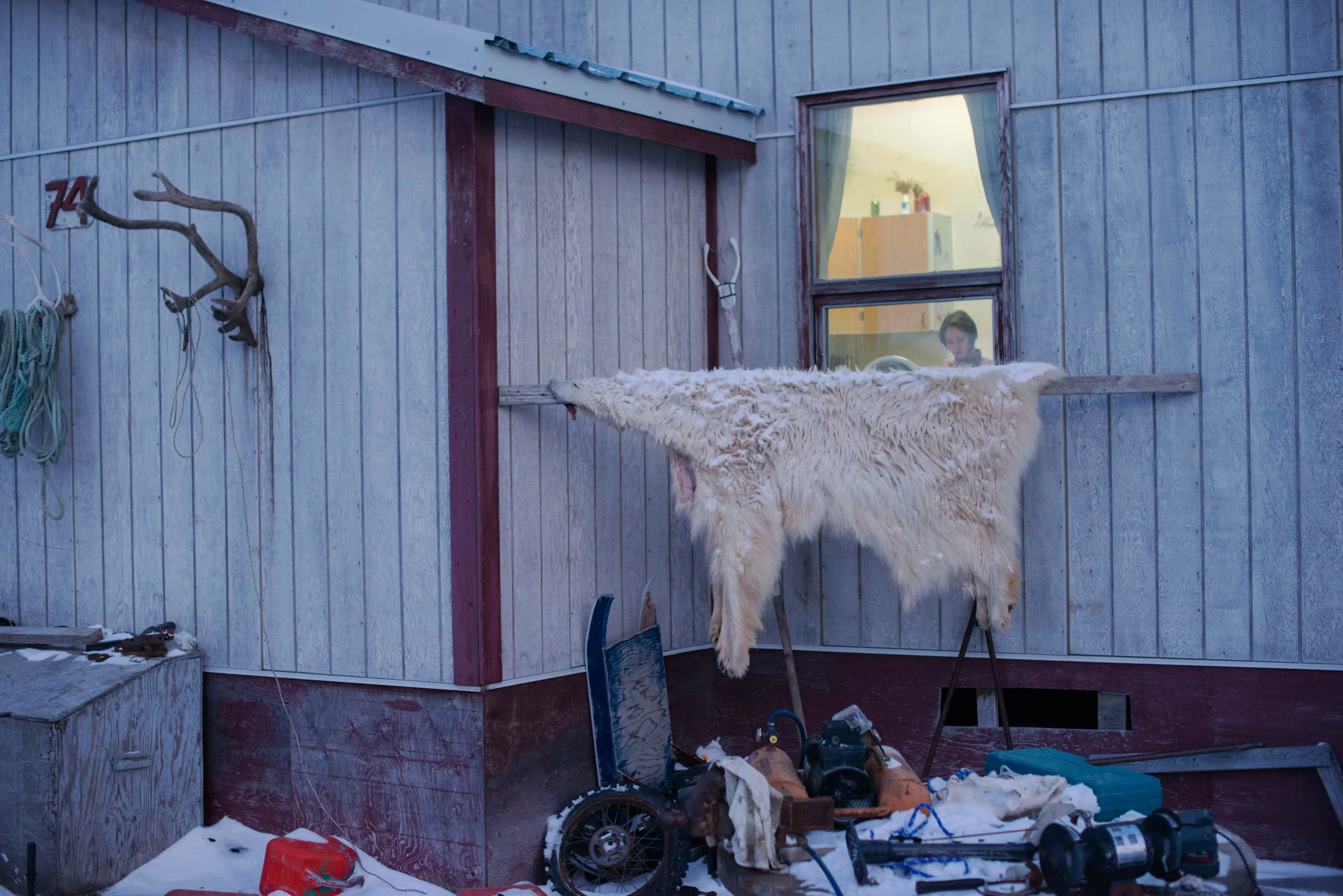 A polar bear skin hanging outside a house in Clyde River. The junk pile in the front yard actually stores of spare parts for reuse or bartering. It’s how you must live in places where supplies have to be brought in by boat during the brief summer weeks of open water, or flown in at huge expense.