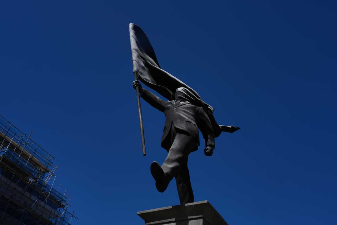 A statue of a man holding a flag covering his face, and signed 'Banksy', which has appeared in Waterloo Place in London, Thursday, April 30, 2026.