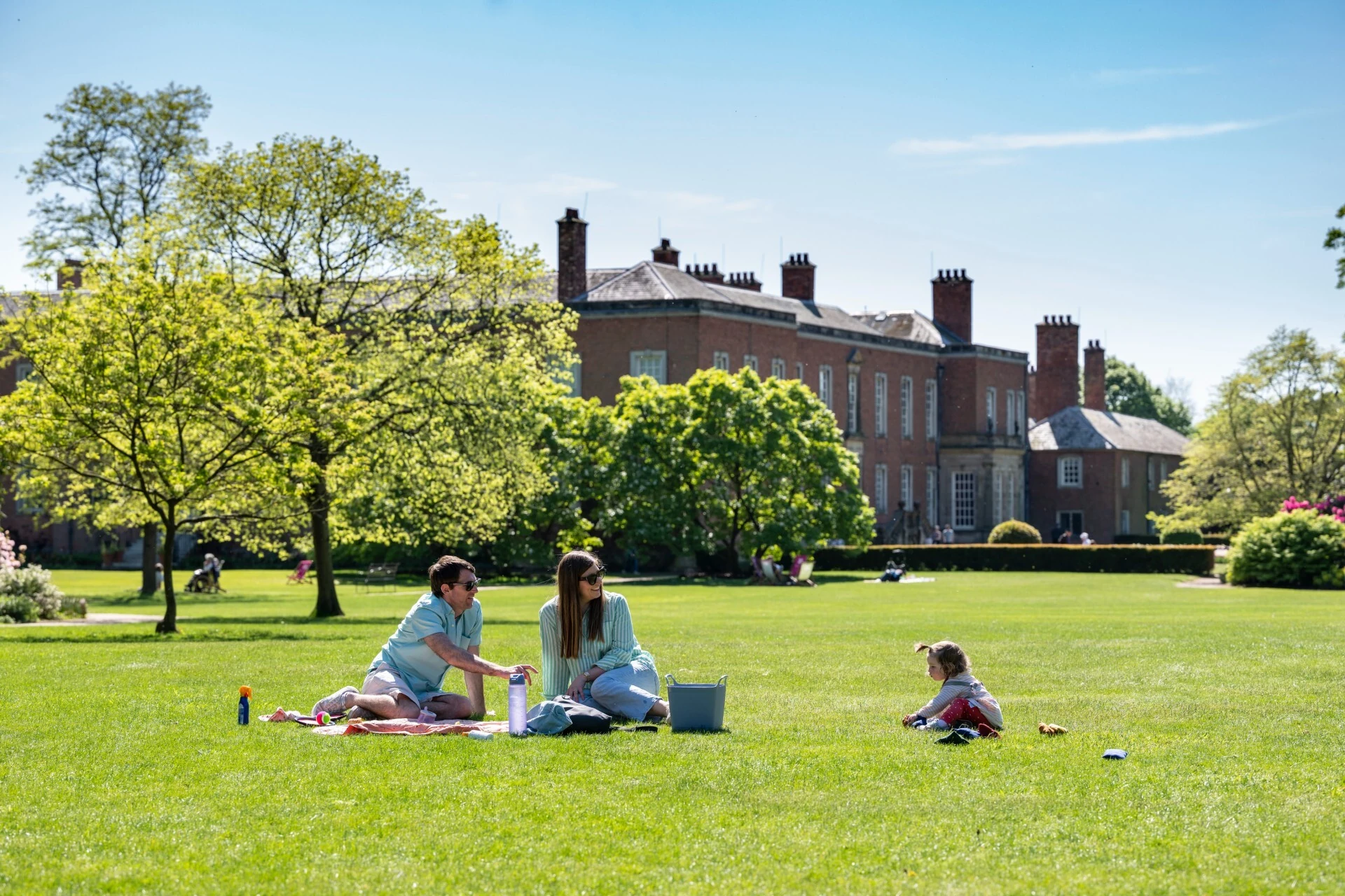 Visitors in the summer Gardens at Dunham Massey, Greater Manchester
