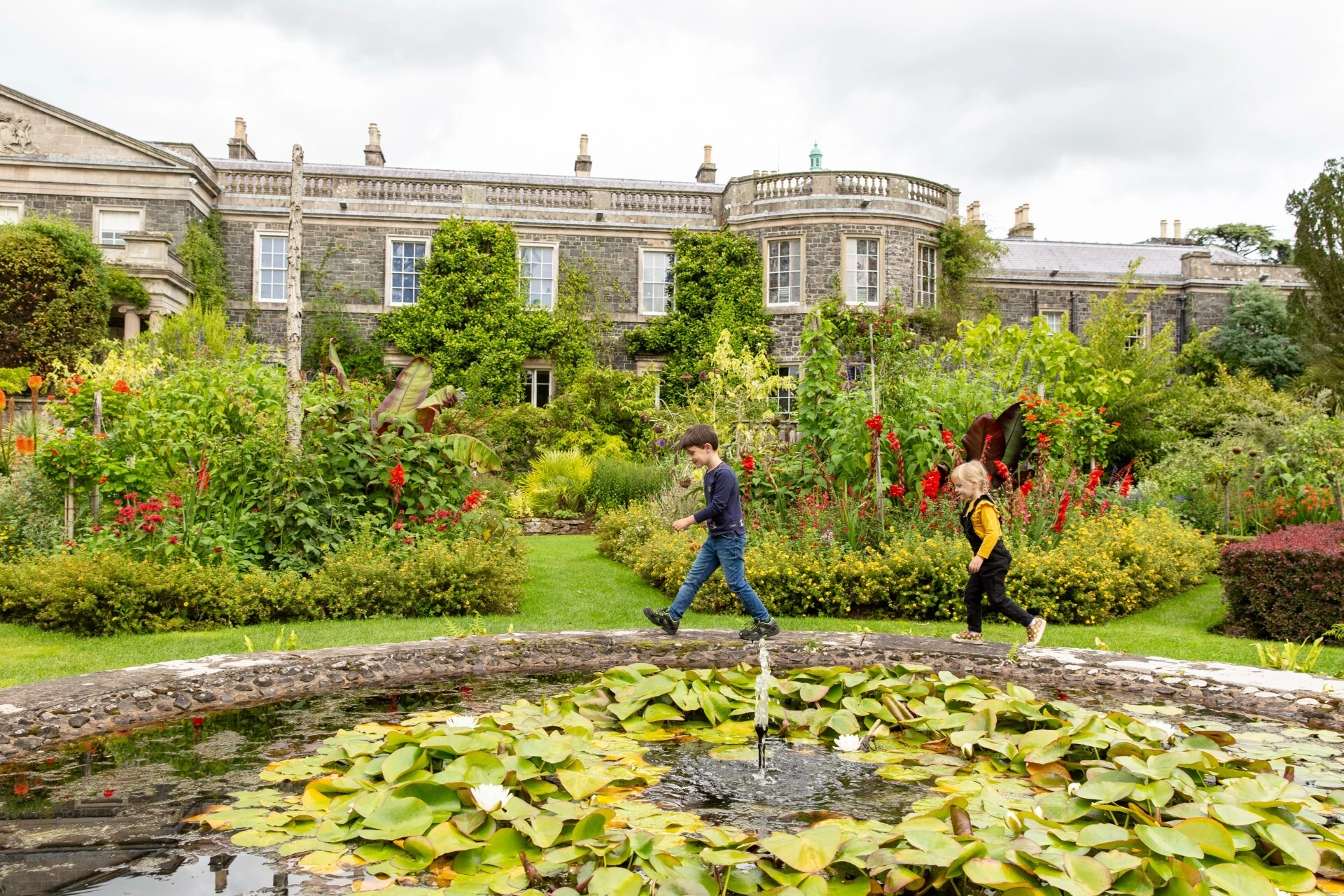 Children exploring the pond in the Italian Garden  at Mount Stewart, County Down, Northern Ireland