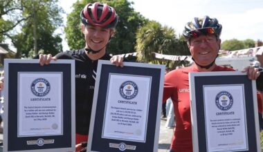 Father-son duo break THREE world records after cycling 18,000 miles around the globe for charity