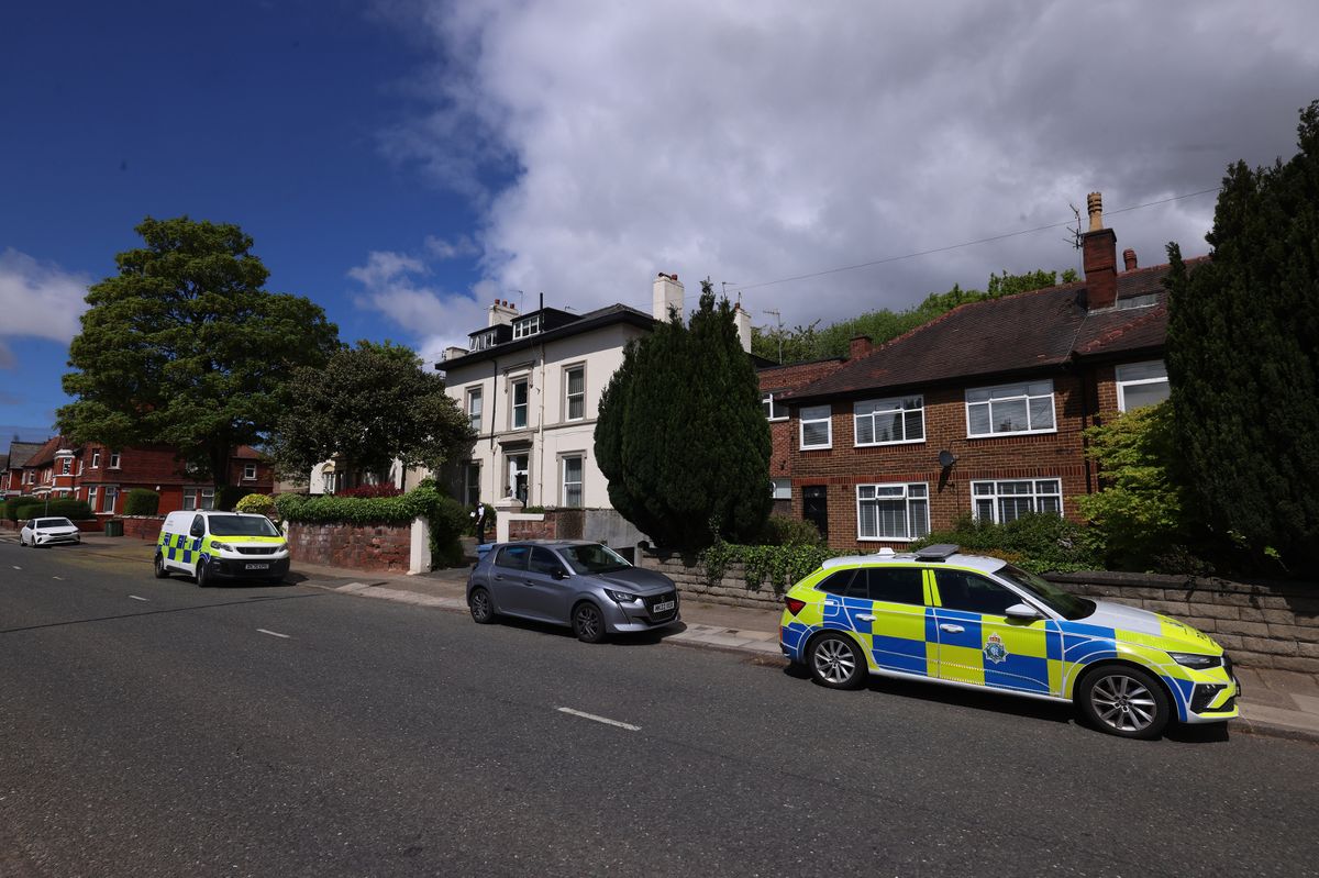 Police outside a white block of flats in Aigburth Road after a man was found dead