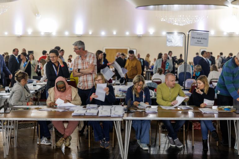 Election staff count votes.