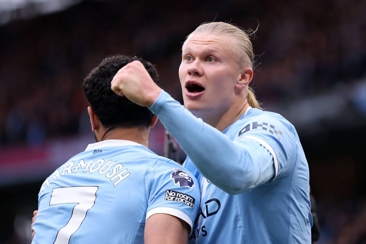 Erling Haaland celebrates scoring his team's second goal with teammate Omar Marmoush during the Premier League match between Manchester City and Brentford at Etihad Stadium. 
