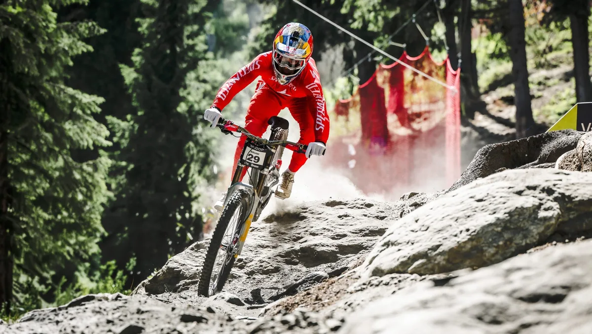 Loic Bruni jumping his Specialized Demo 11 through a rocky section on a World Cup track.