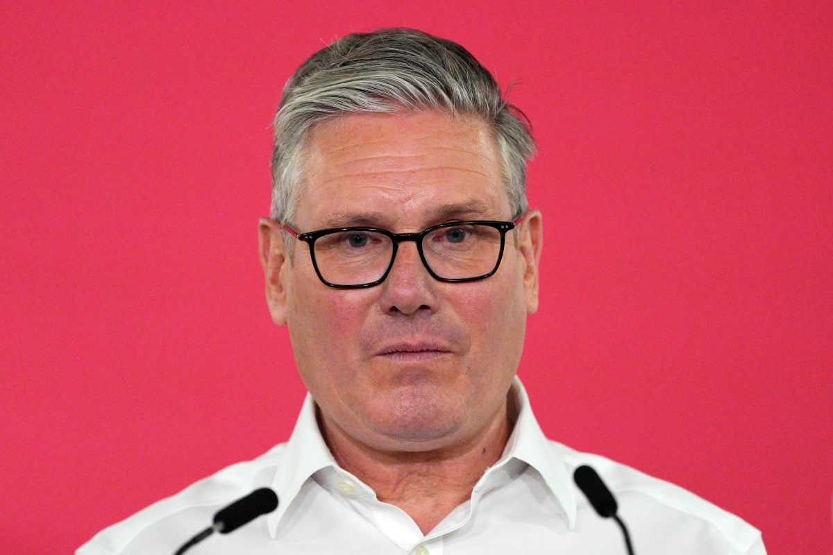 Keir Starmer delivering a speech on May 11, addressing political issues, in a formal setting with an audience.