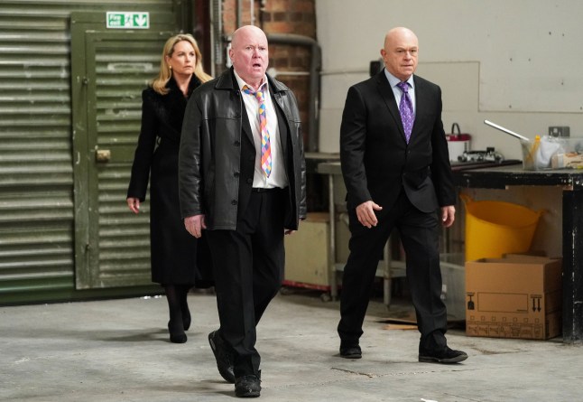 Sam, Phil and Grant Mitchell entering a warehouse in EastEnders