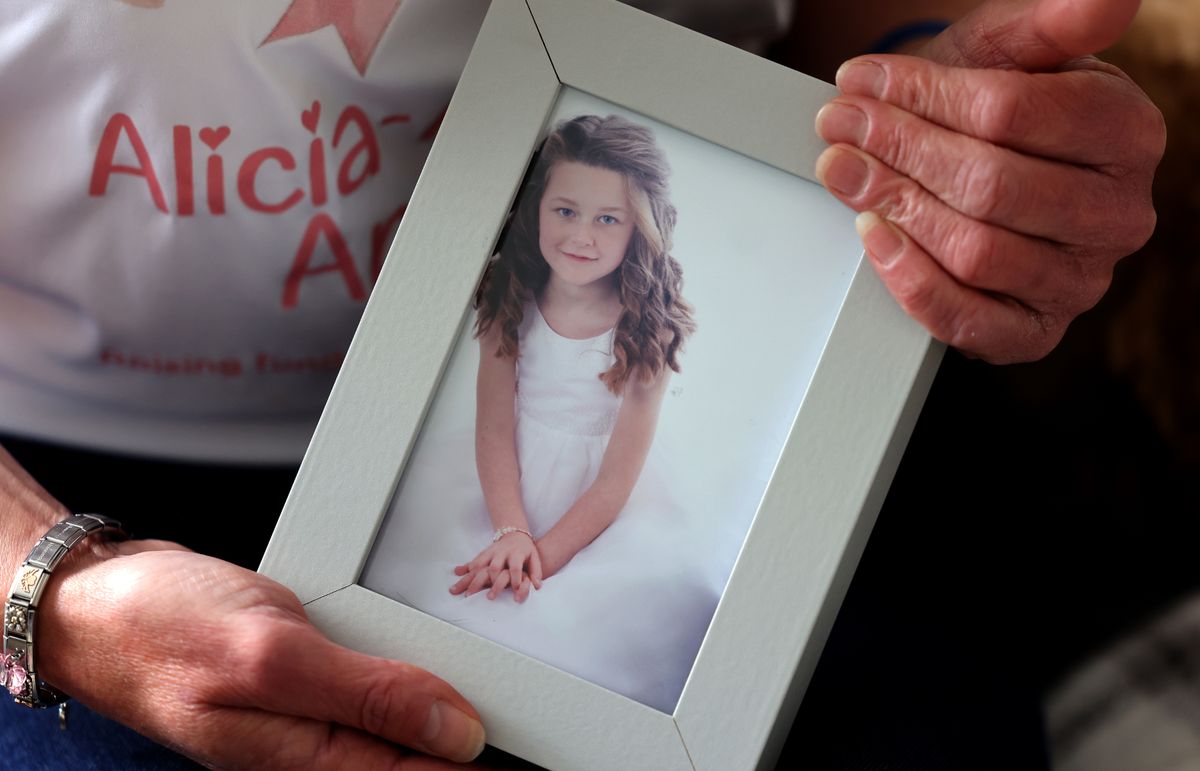person holding picture of little girl