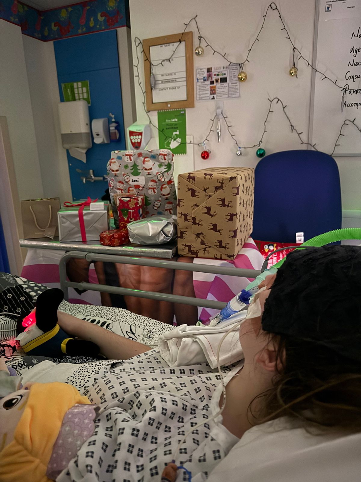 Lexi Brown, looking at gifts in hospital