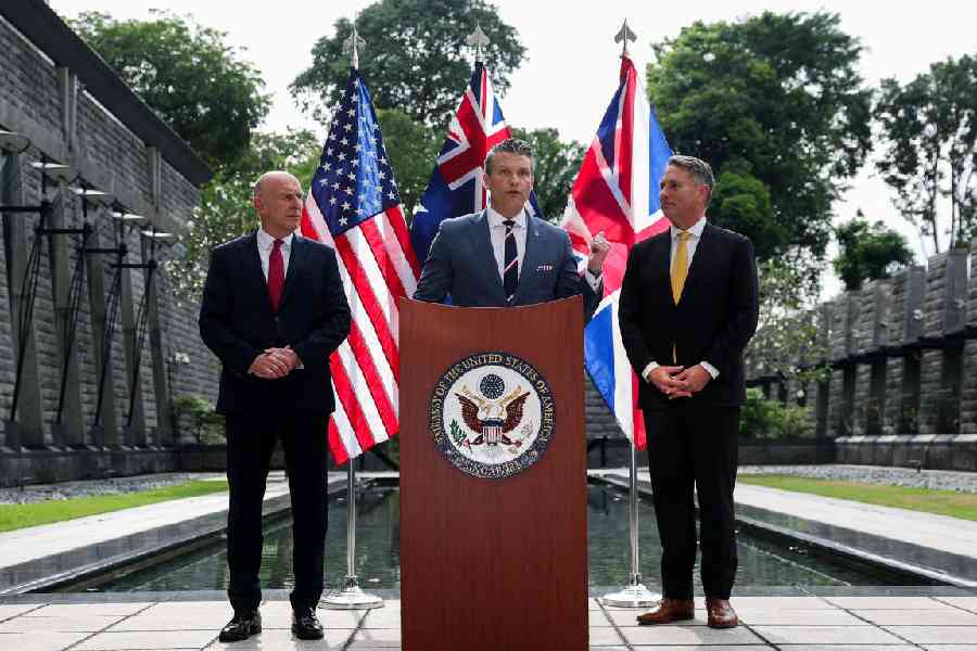Australian Defence Minister Richard Marles and British Defence Secretary John Healey look on as US Secretary of Defense Pete Hegseth speaks during an AUKUS Defence ministers' press huddle at the U.S. Embassy in Singapore, May 30, 2026.