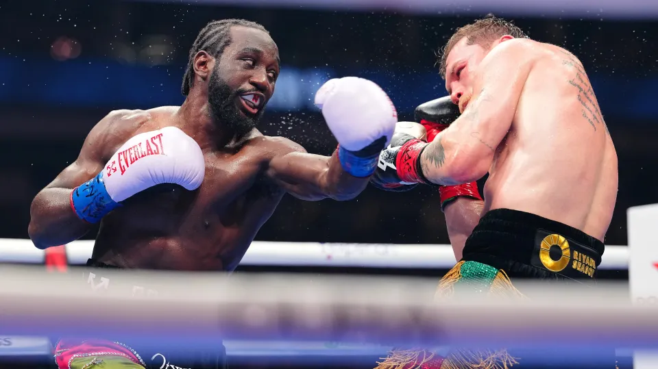 Terence Crawford punches Canelo during their 'Fight of the Century' at Allegiant Stadium