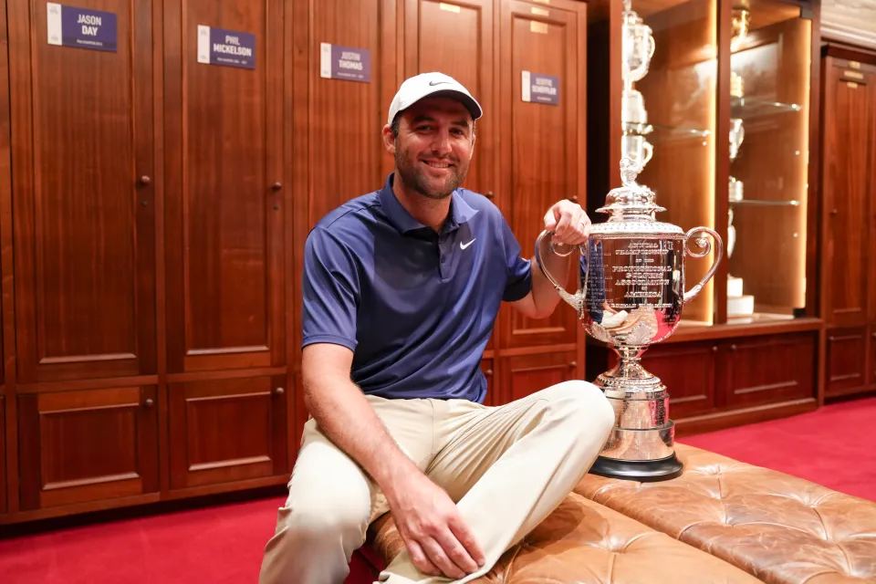 Scottie Scheffler poses with the Wanamaker trophy in the clubhouse locker room after winning the PGA Championship at Quail Hollow Club on Sunday, May 18, 2025