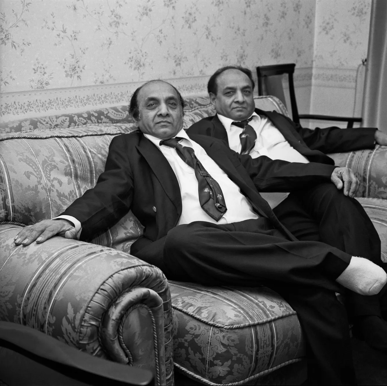 Ramesh and Suresh relaxing on a couch in Middlesex.