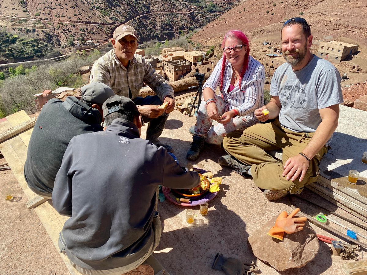 People sat eating together outdoors
