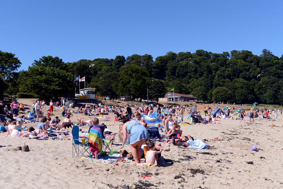 People enjoy the sun on Silver Sands beach at the start of the Scottish school holidays as the heatwave continues, on July 3, 2018 in Aberdour, Scotland.