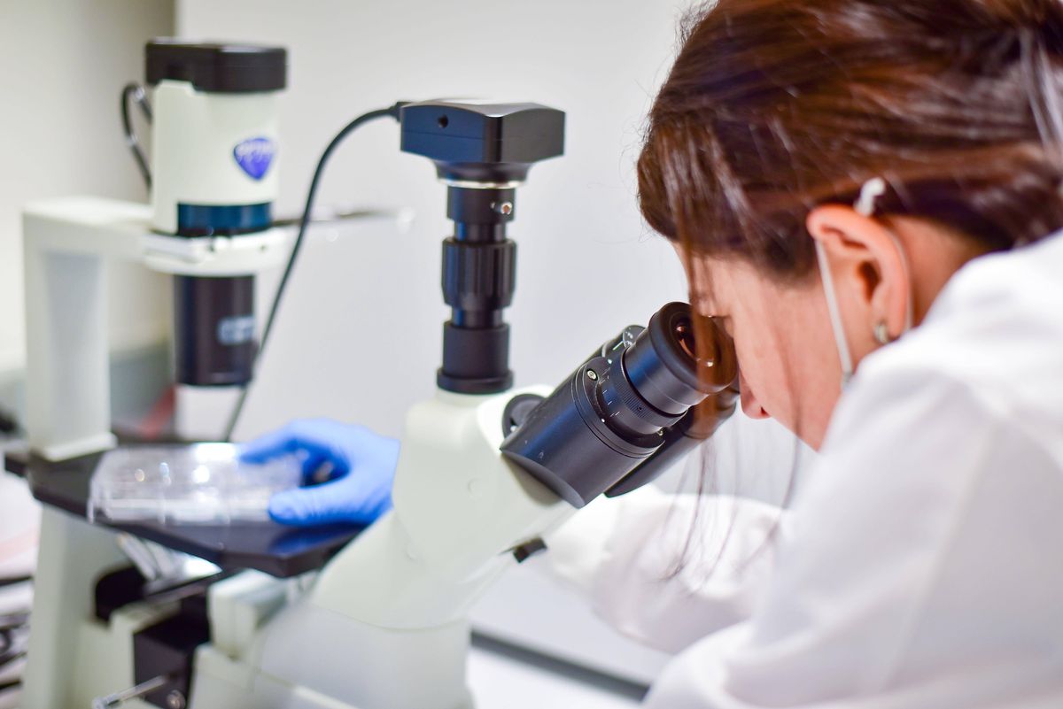 A woman using a microscope