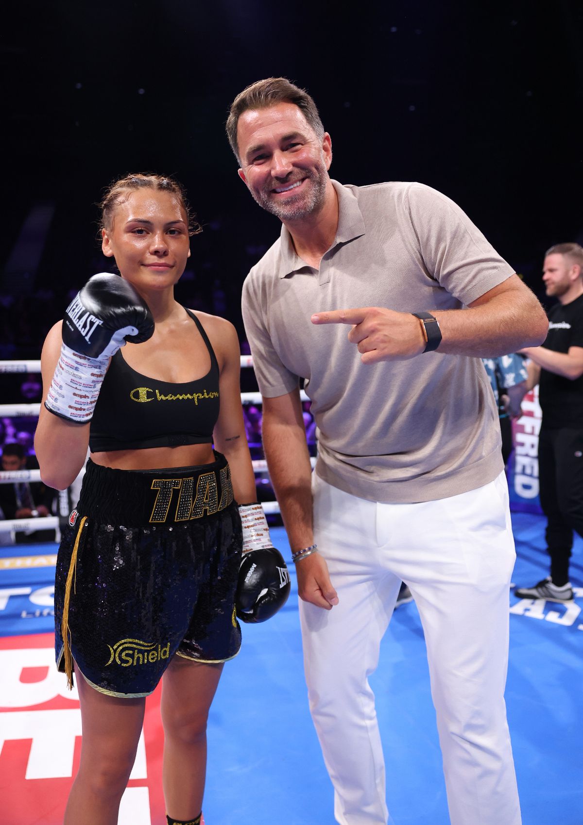 Tiah Ayton celebrates beating Sara Orszagi with Chairman of Matchroom Boxing Eddie Hearn after their Super Bantamweight Contest at BP Pulse Live