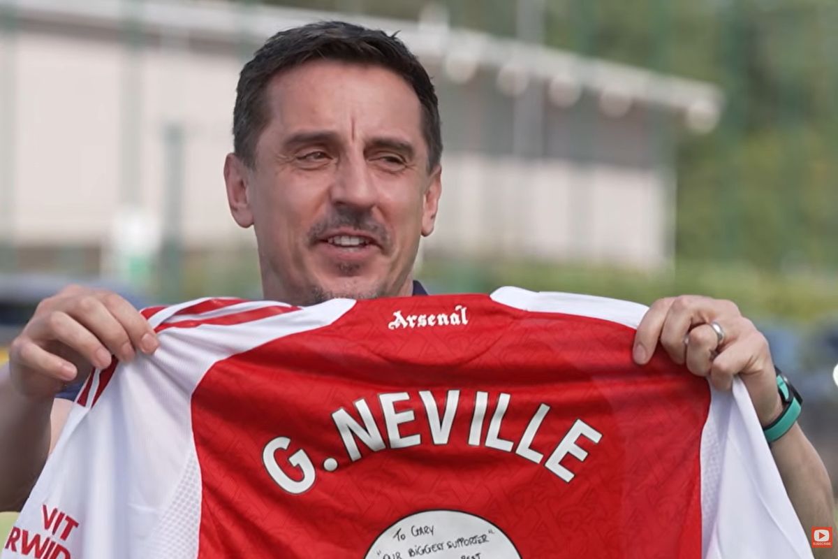 Gary Neville is presented with an Arsenal shirt that is signed 'our best supporter'