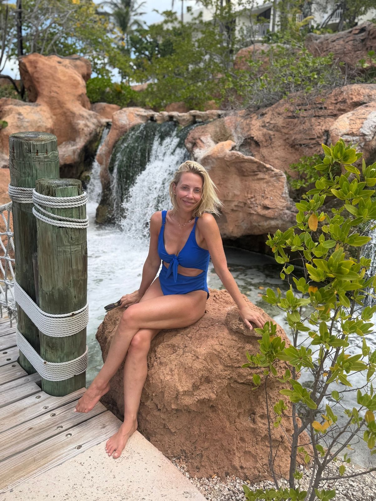 Laura hamilton in swimsuit in front of waterfall