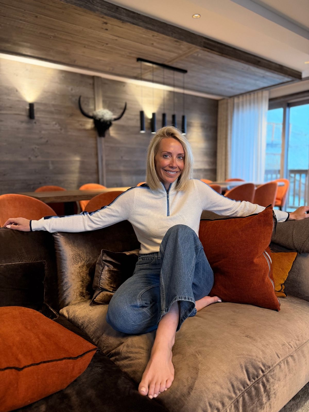 laura hamilton on a sofa with arms out