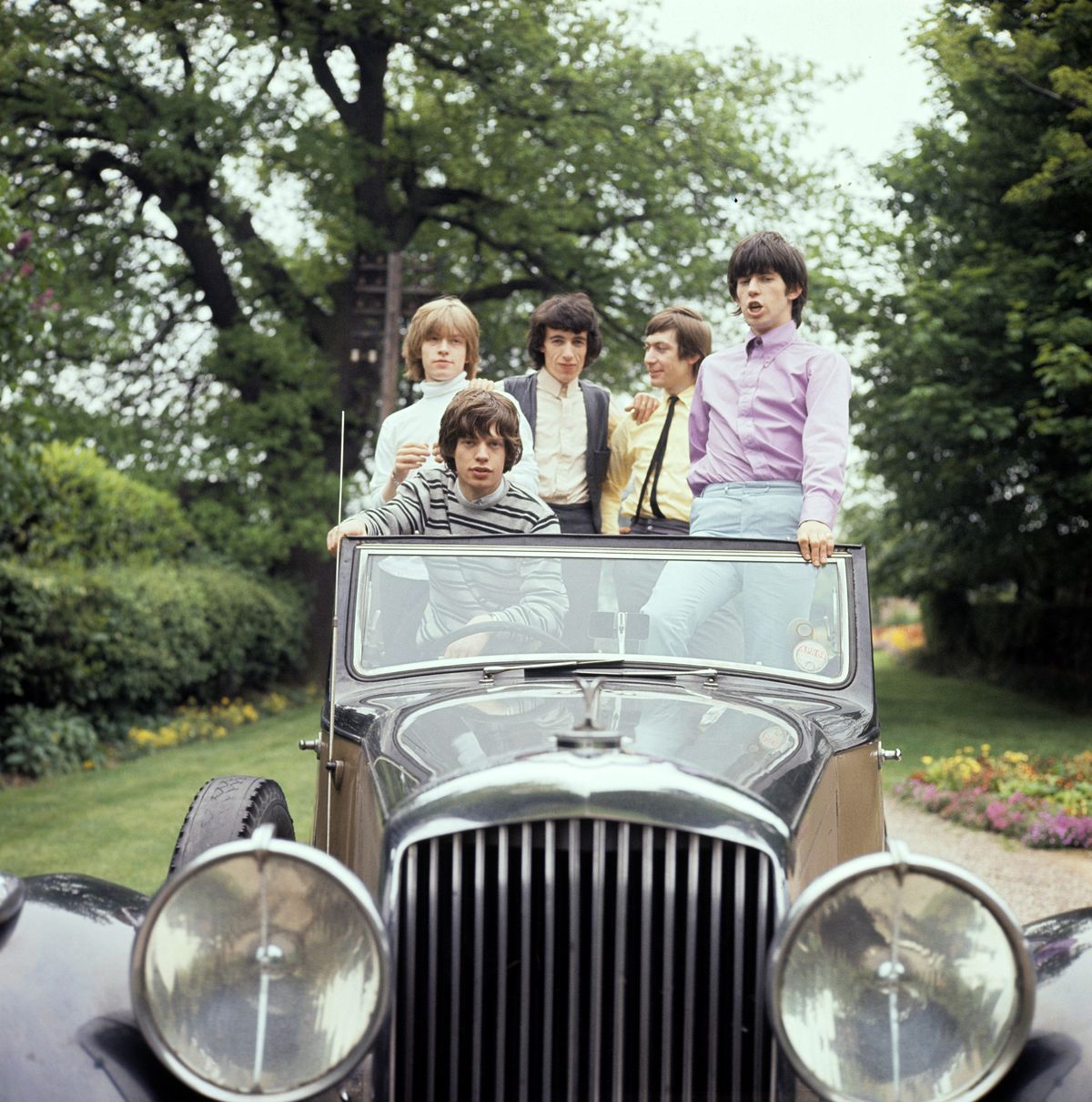 The Rolling Stones, in a vintage car 1964. From left to right Brian Jones, Mick Jagger, Bill Wyman, Charlie Watts and Keith Richards