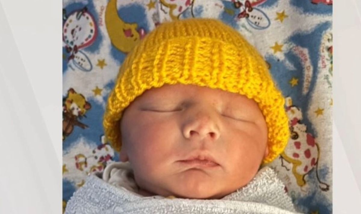 A baby in a yellow hat