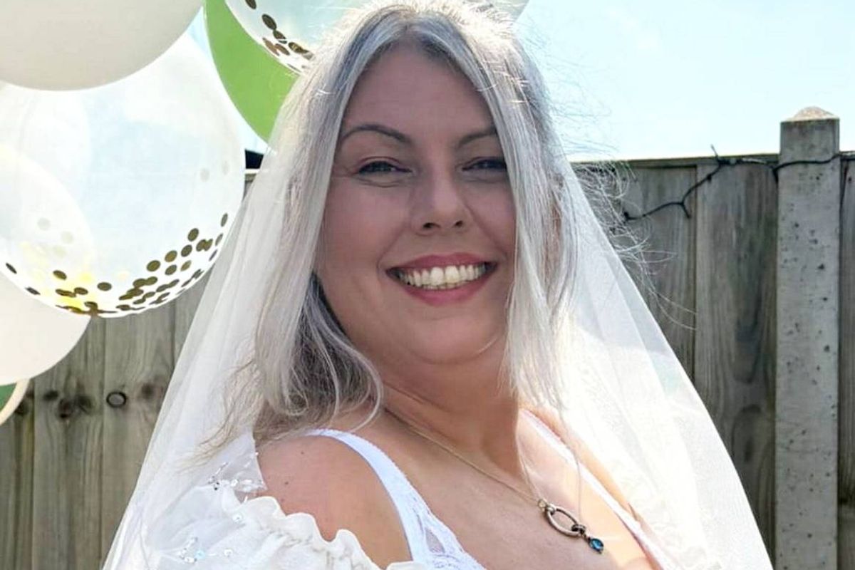 Ali Burridge in a wedding dress she was going to wear on her 50th birthday trip