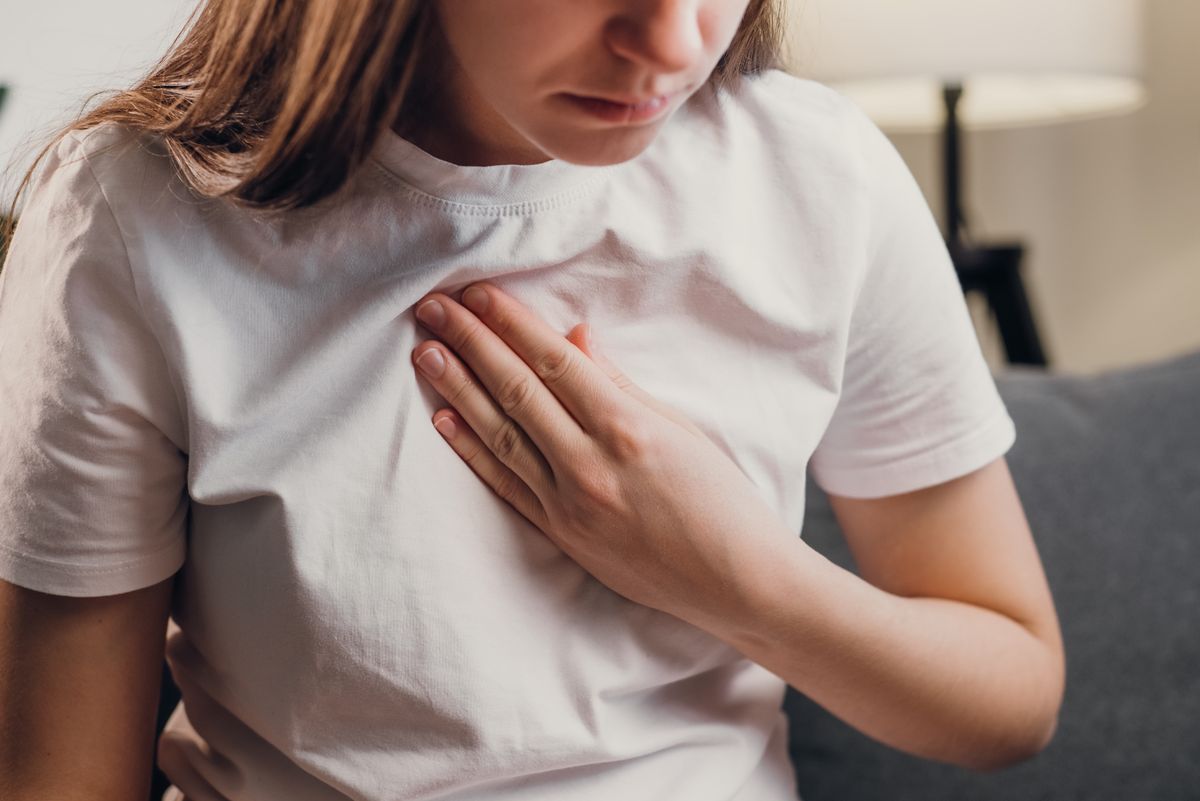 Woman holding her chest