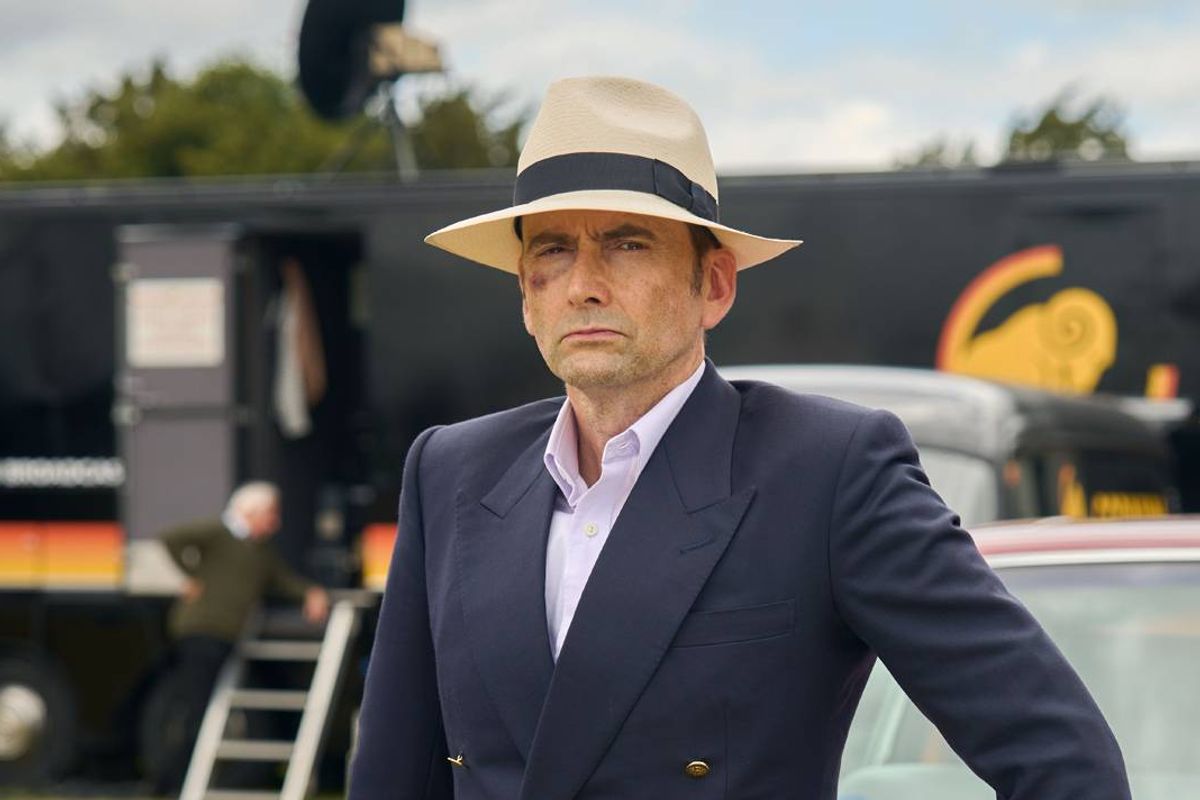 A man in a hat with a bruise on his face looks serious