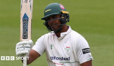 Rishi Patel raises his bat after reaching his 50 against Sussex