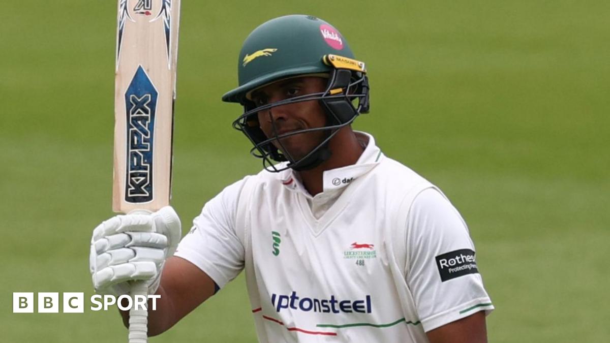 Rishi Patel raises his bat after reaching his 50 against Sussex