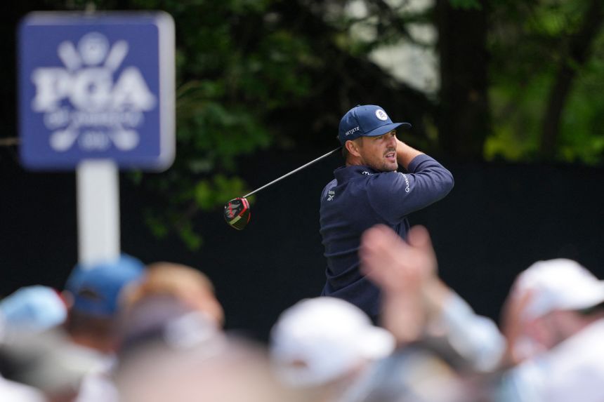 A crowd watches Bryson DeChambeau tee off on the fourth hole Thursday.