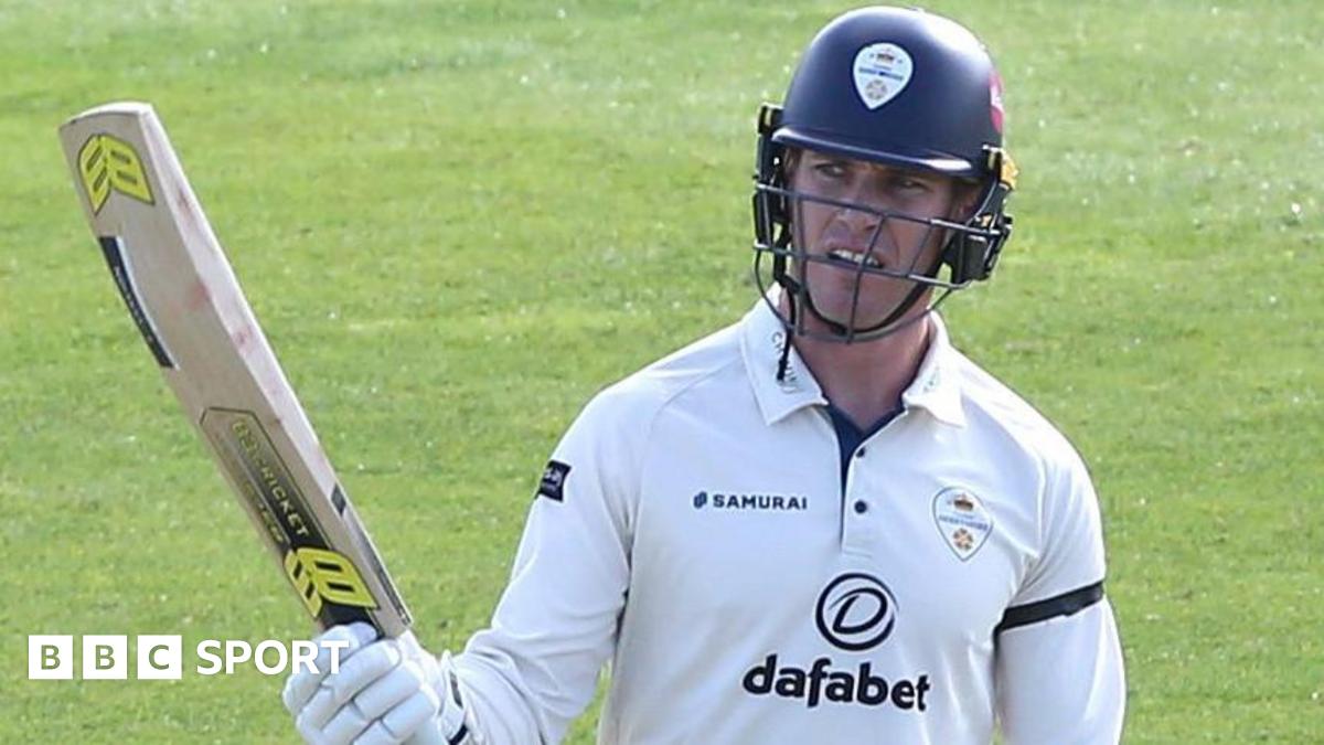 Luis Reece raises his bat after reaching a half-century for Derbyshire
