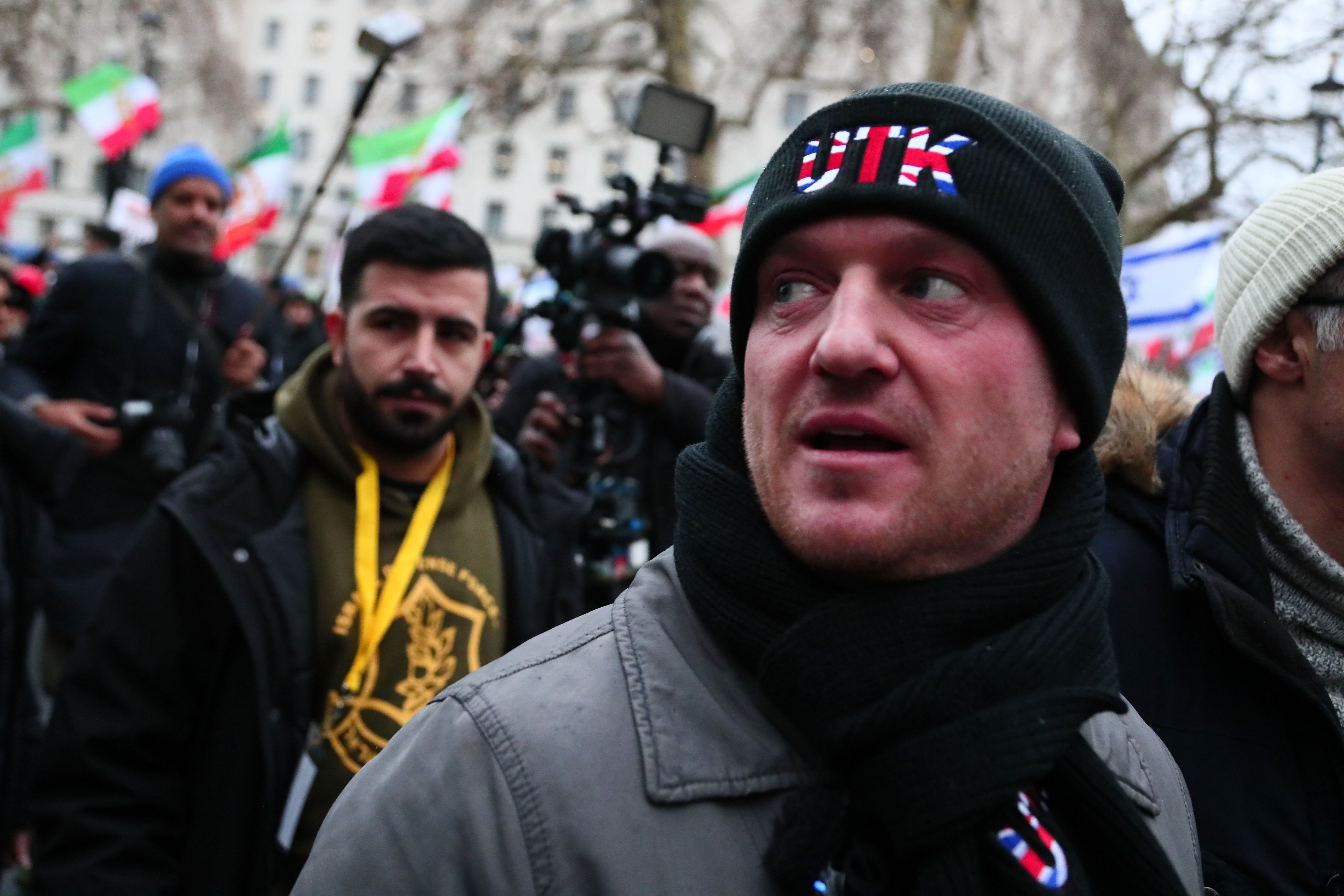 Stephen Yaxley-Lennon, known as Tommy Robinson, wears a UTK logo (