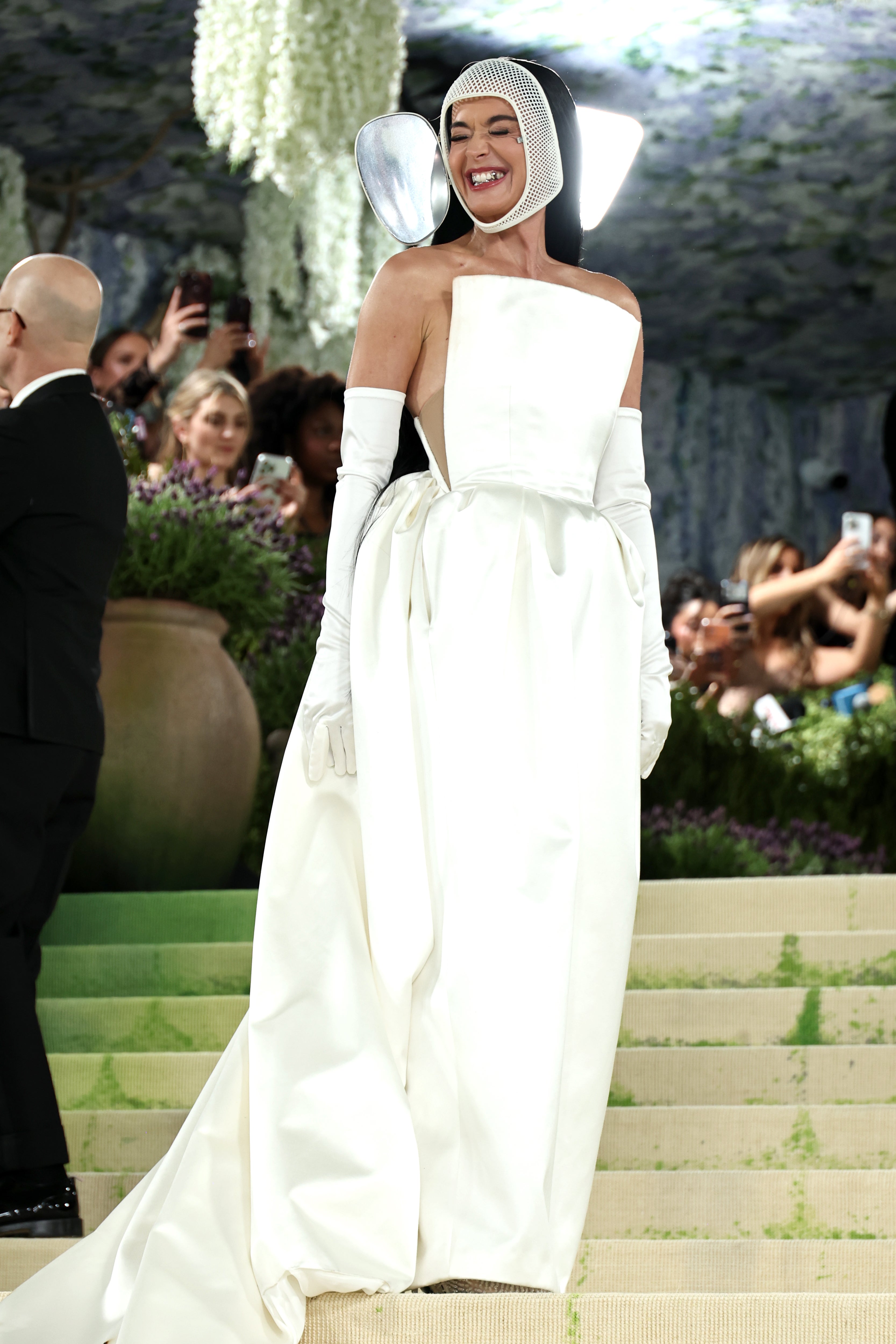 Surprise! Katy Perry appears from behind the mask