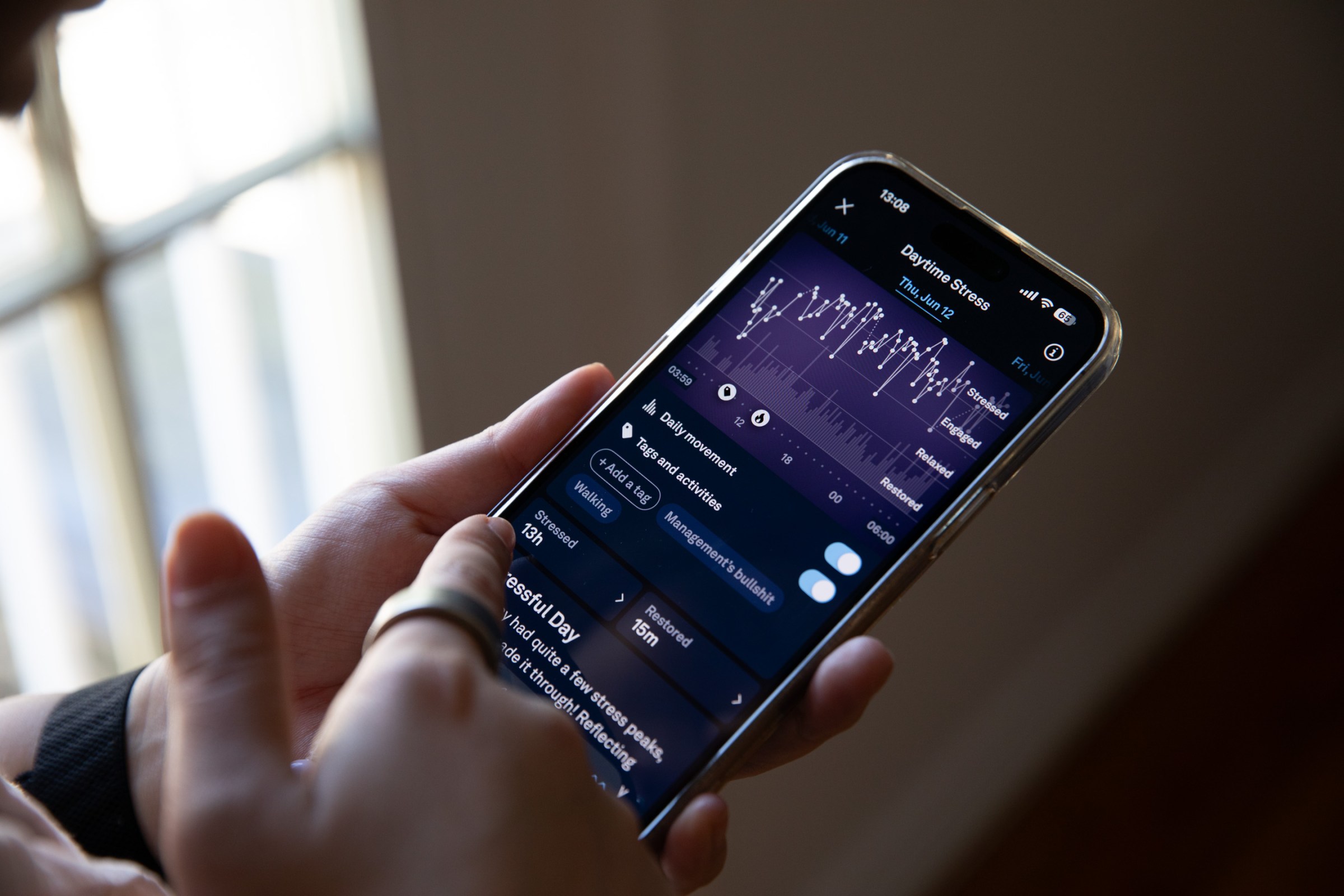 Person looking at daytime stress metrics in the Oura app.