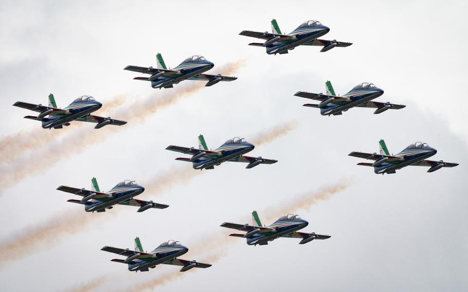 Nine military aircraft fly in formation.