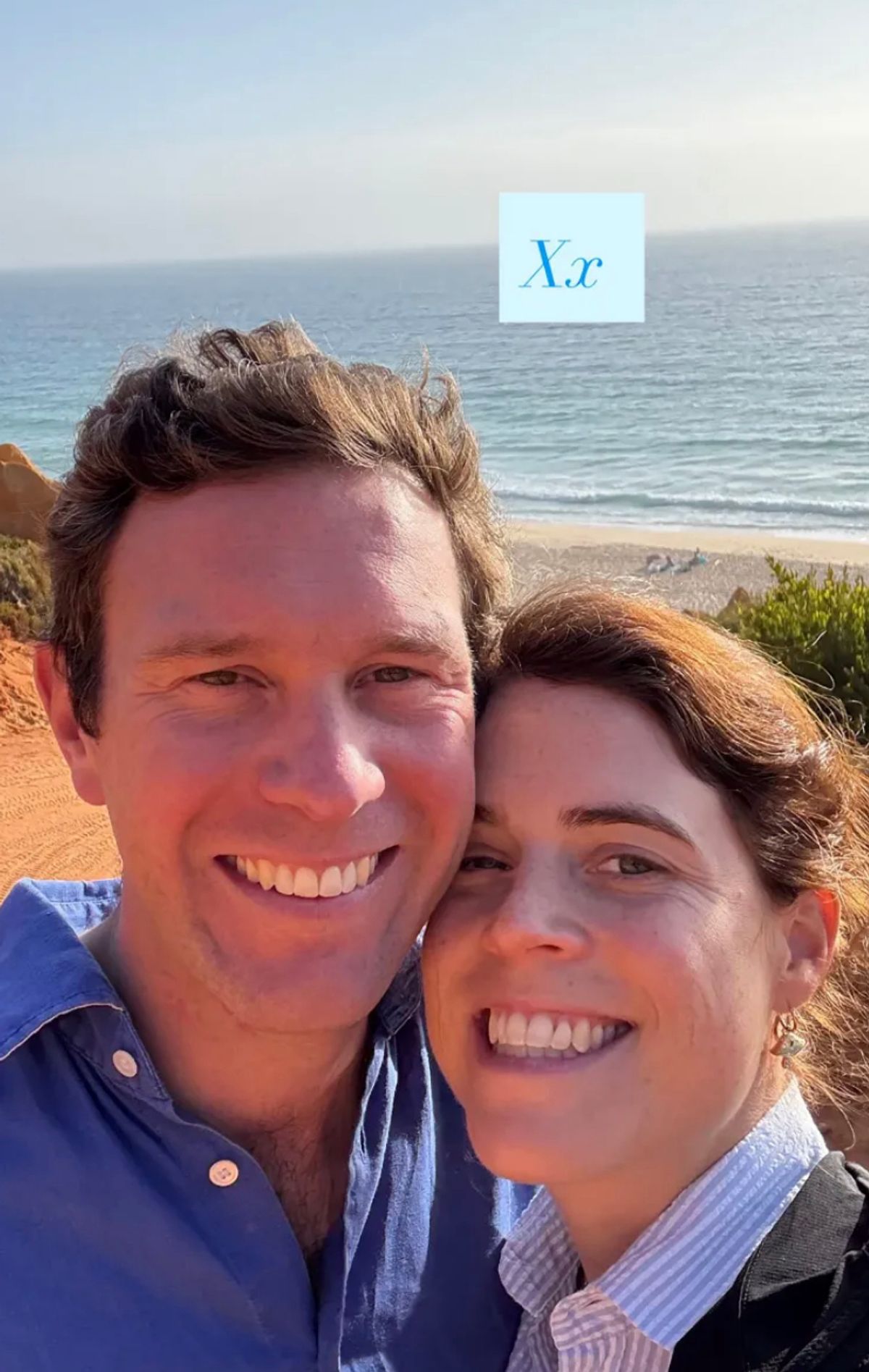 Princess Eugenie and her husband smiling on a beach