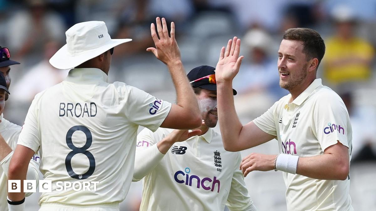 Stuart Broad and Ollie Robinson high-five each other while playing for England
