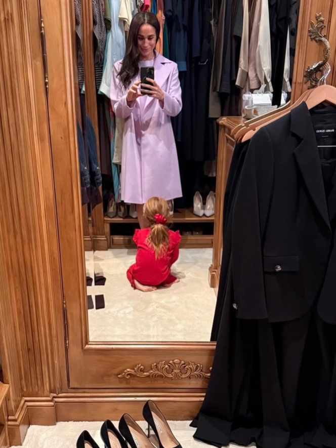 Meghan Markle taking a mirror selfie with her daughter Lilibet in a closet.