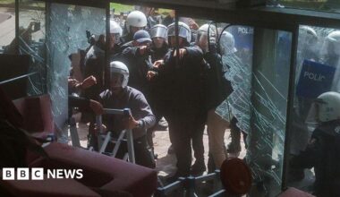 Riot police fire tear gas as they break the entrance door of the party’s headquarters on May 24, 2026 in Ankara, Turkey.
