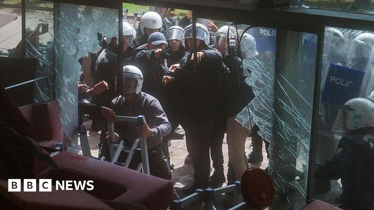 Riot police fire tear gas as they break the entrance door of the party’s headquarters on May 24, 2026 in Ankara, Turkey.