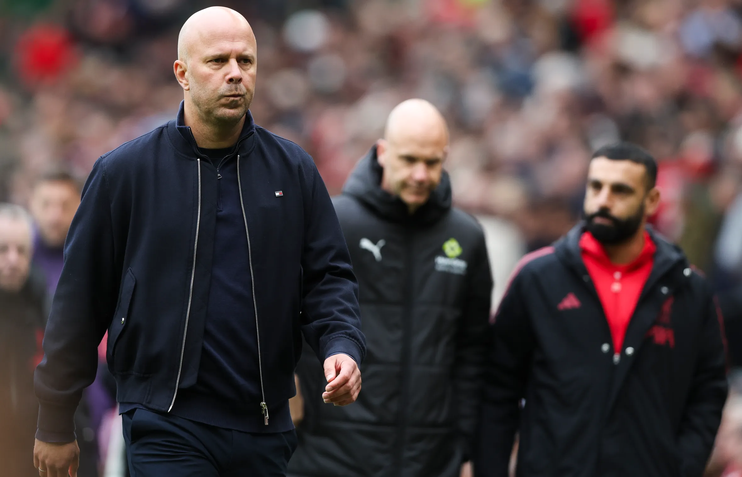 Arne Slot, Manager of Liverpool, walks on the field at half time.