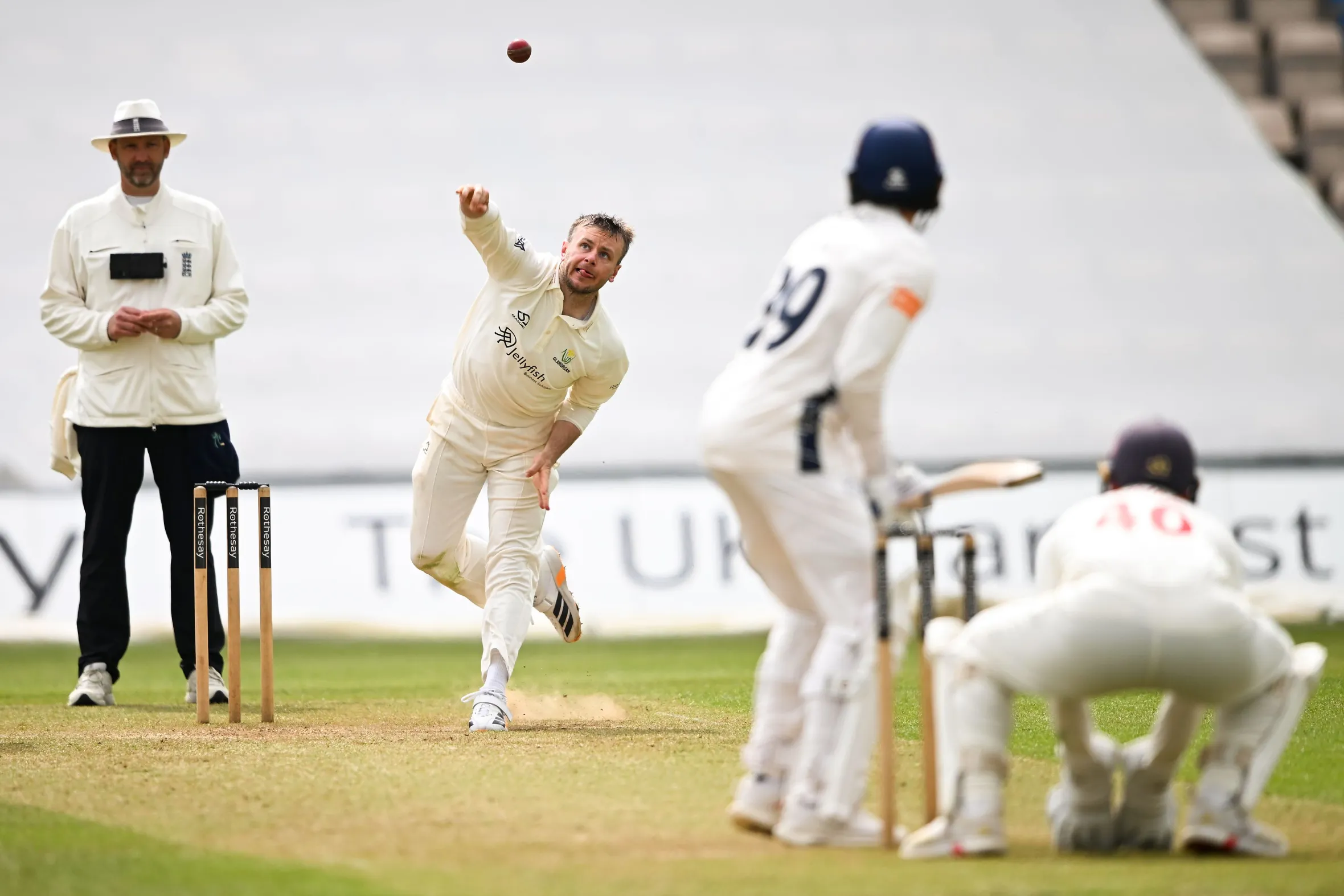 Mason Crane of Glamorgan bowling to Codi Yusuf during a cricket match.