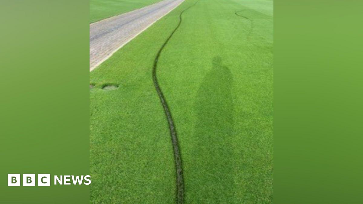 A deep line running across a tennis lawn.
