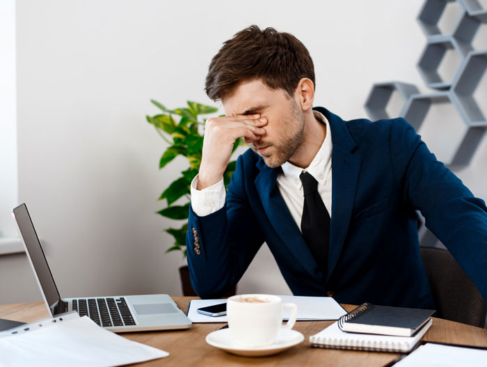 Stressed manager in office frustrated with AI integration challenges Stressed manager in office frustrated with AI integration challenges