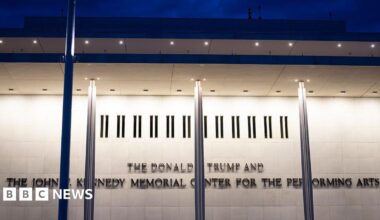 The Kennedy Center is seen lit up in the dark across the Potomac River in Washington DC
