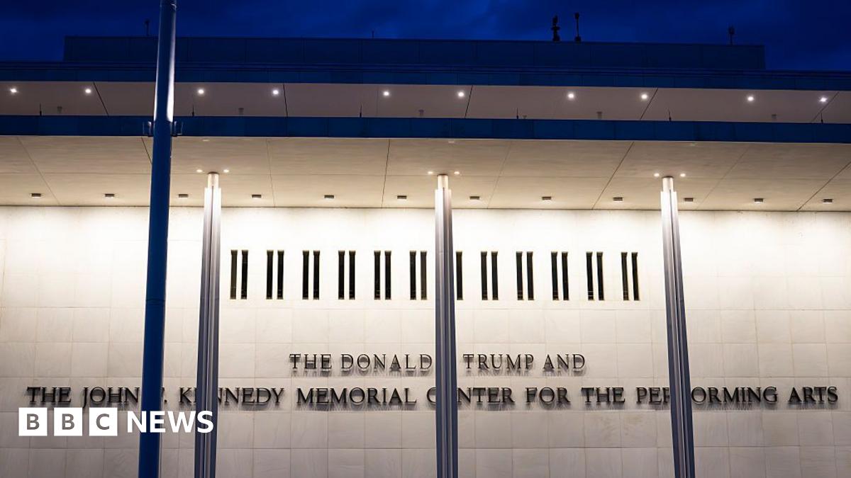 The Kennedy Center is seen lit up in the dark across the Potomac River in Washington DC