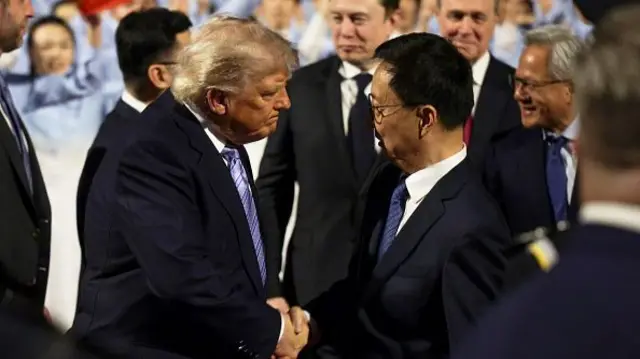 Donald Trump shakes hands with Vice President of China Han Zheng (R) as he walks to his motorcade after arriving at Beijing Capital International Airport. Behind him are Tesla CEO Elon Musk and Nvidia's Jensen Huang.